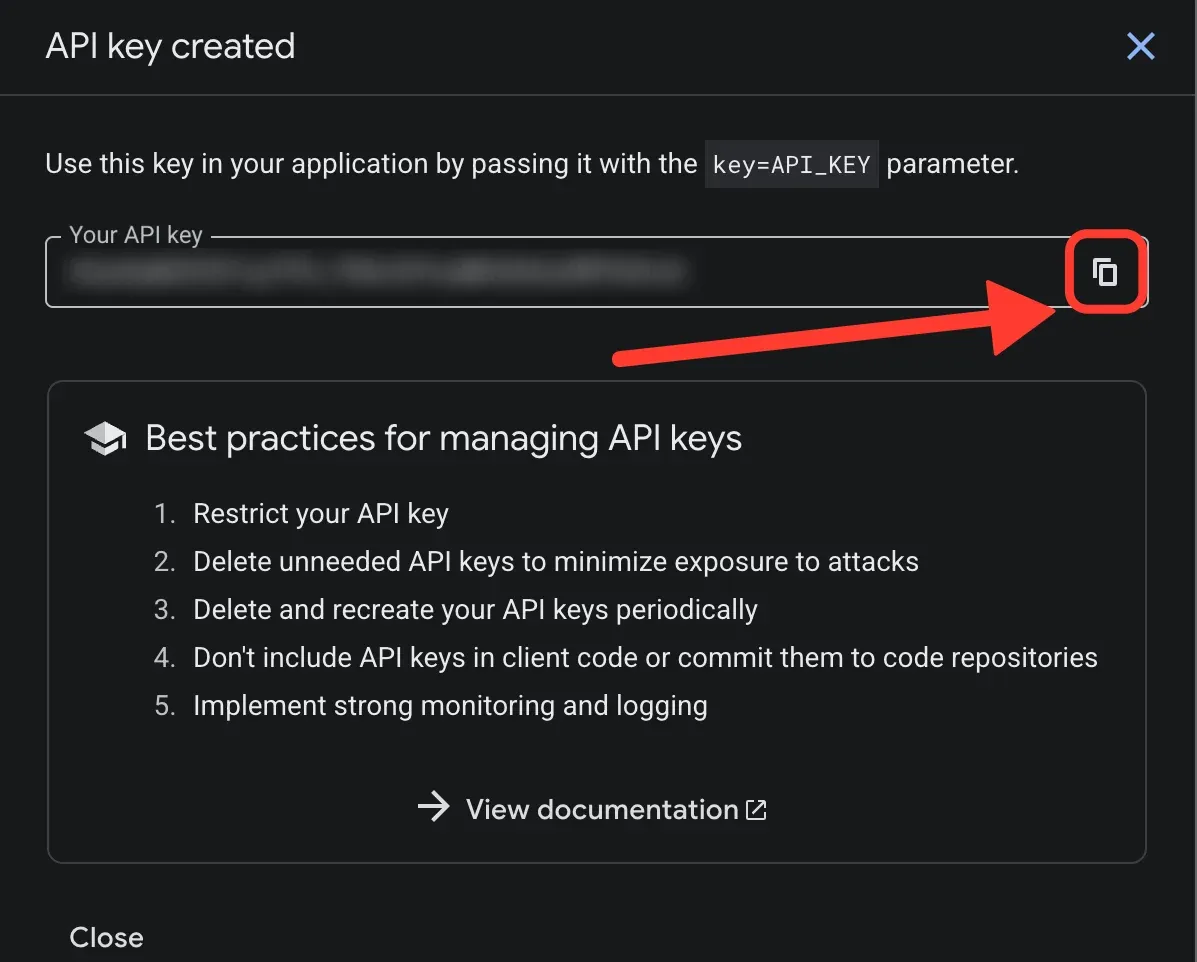 The API key created panel, with the copy button highlighted and the key blurred